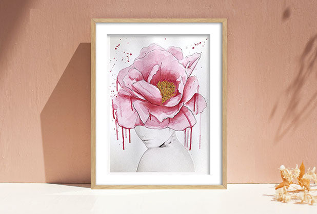 Artwork in frame of black and white woman with large pink flower covering her face.